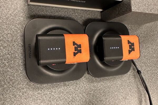 Microphones on top of instructor pedestal with charging base