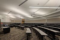 Back of room view of student tiered fixed-table and chair seating 