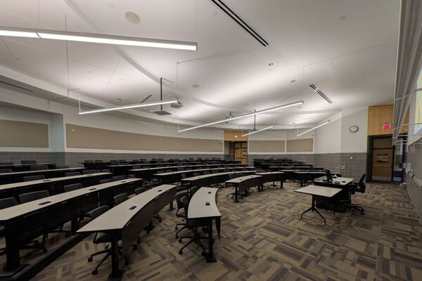 Back of room view of student tiered fixed-table and chair seating 