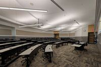 Back of room view of student tiered fixed-table and chair seating 