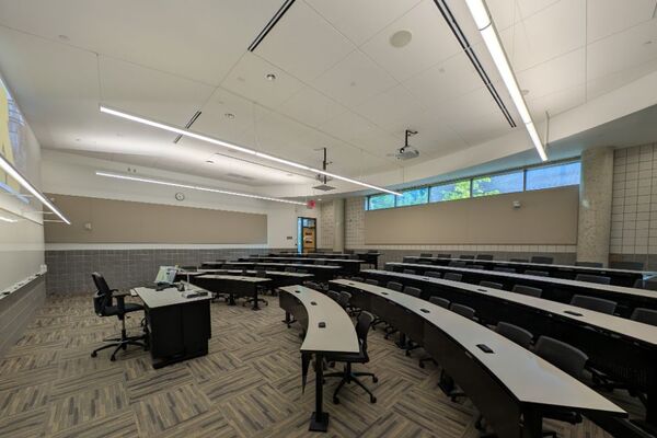 Back of room view of student tiered fixed-table and chair seating 