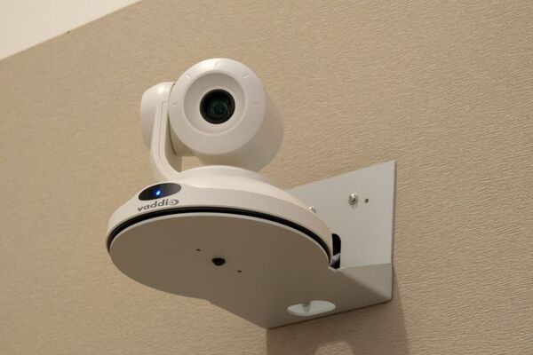 Camera mounted to a wall and instructor enabled adjustments to the lens to allow the instructor to be "seen" by the camera in more locations around the room