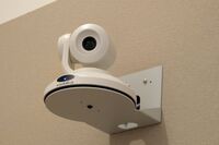 Camera mounted to a wall and instructor enabled adjustments to the lens to allow the instructor to be "seen" by the camera in more locations around the room
