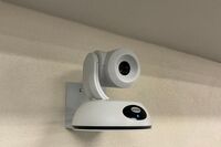 Camera mounted to a wall and instructor enabled adjustments to the lens to allow the instructor to be "seen" by the camera in more locations around the room