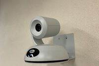 Camera mounted to a wall and instructor enabled adjustments to the lens to allow the instructor to be "seen" by the camera in more locations around the room