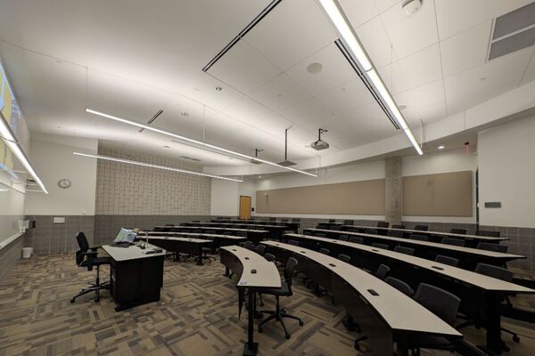 Back of room view of student tiered fixed-table and chair seating 