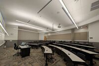 Back of room view of student tiered fixed-table and chair seating 