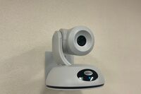 Camera mounted to a wall and instructor enabled adjustments to the lens to allow the instructor to be "seen" by the camera in more locations around the room