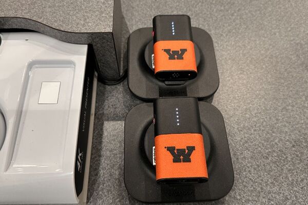 Pedestal - surface view of two wireless mics in charging base