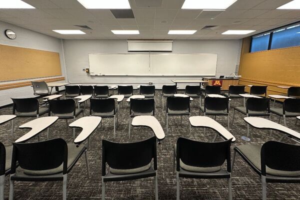 Front of room view with lectern on right in front of markerboard 