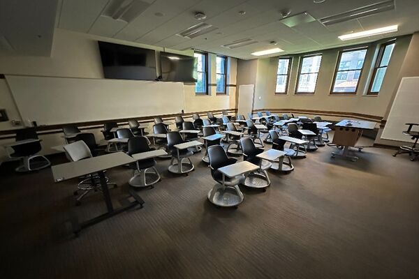 Back of room view of student tablet arm seating and markerboard at rear of room