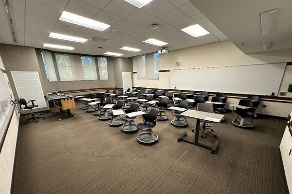 Back of room view of student tablet arm seating and markerboard on rear wall