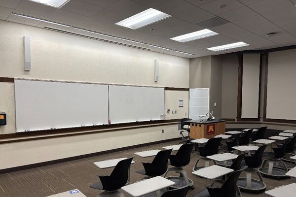 Front of room view with lectern on right in front of markerboard 