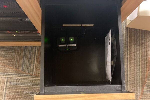 Pedestal - inside view of drawer showing two wireless mics in charging base