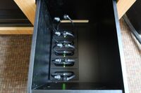 Pedestal - inside view of drawer showing assistive listening devices in charger