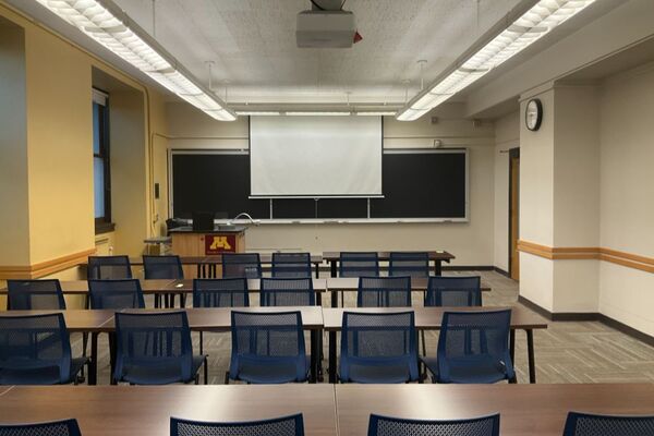 Front of room view with lectern on left in front of chalkboard