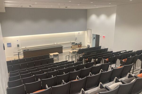 Front of room view with lectern on right side and demonstration bench on left