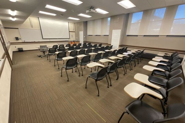 Front of room view with lectern on right in front of markerboard 