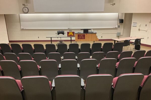 Front of room view with lectern on right in front of markerboard