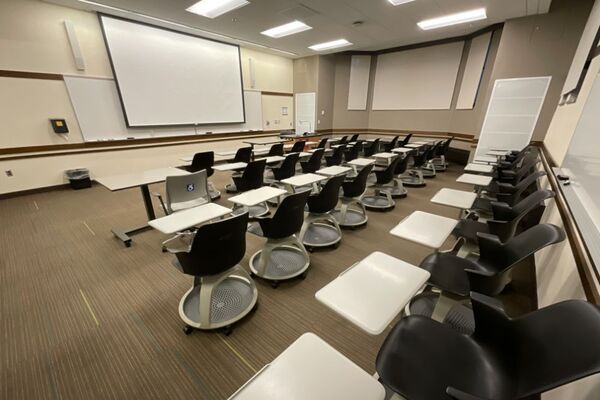 Front of room view with lectern on right in front of markerboard