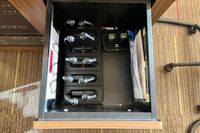  Pedestal - inside view of drawer showing two wireless mics in charging base and assistive listening devices in charger