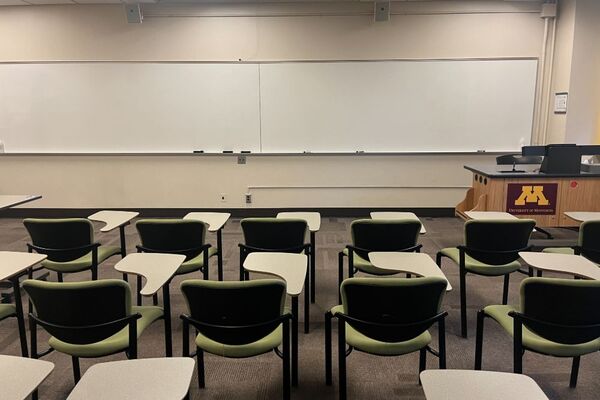 Front of room view with lectern on right in front of markerboard 