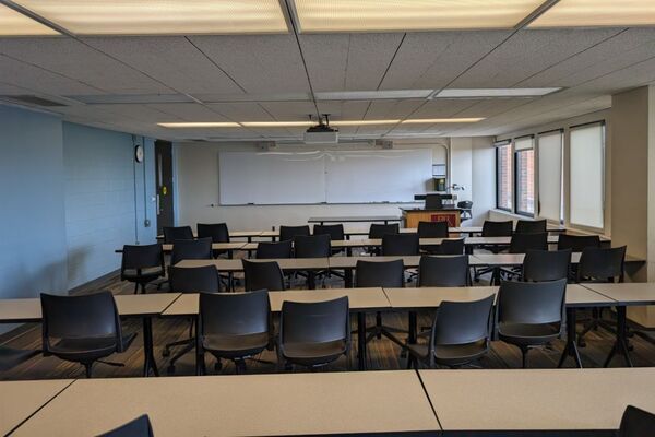  Front of room view with lectern on right in front of markerboard and exit door on the left