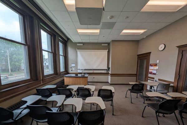 Front of room view with lectern on left in front of markerboard 