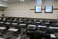 Back of room view of student tablet arm seating and markerboard at rear of room