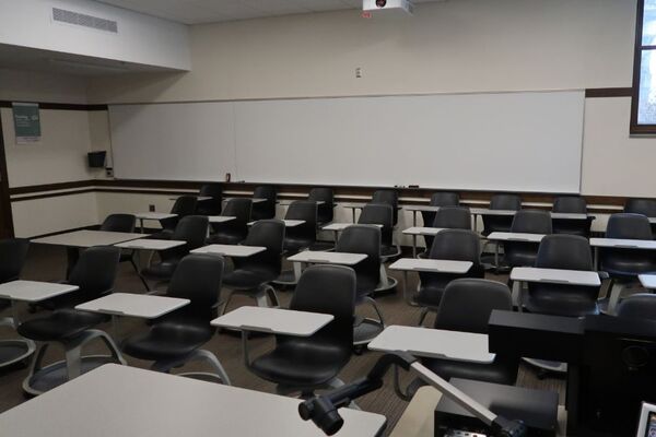 Back of room view of student tablet arm seating and markerboard on rear wall