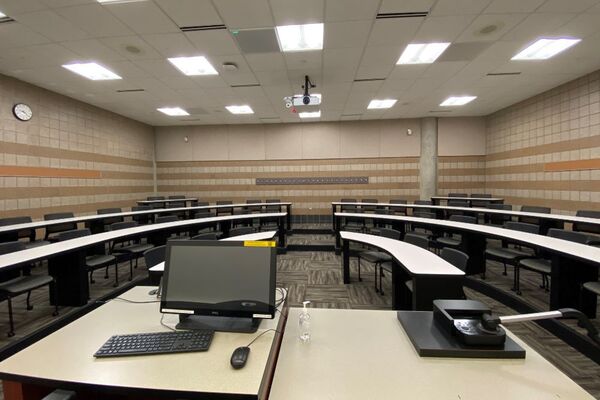 Back of room view of student tiered fixed-table and chair seating