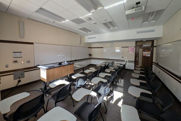 Front of room view with lectern on left in front of markerboard 