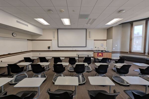 Front of room view with lectern on right in front of markerboard 