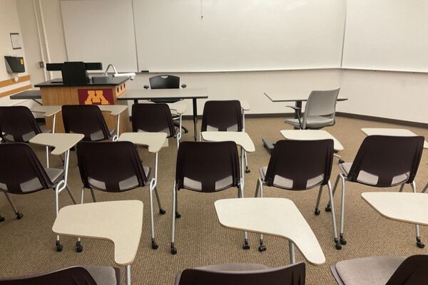 Front of room view with lectern on left and projection screen fully raised