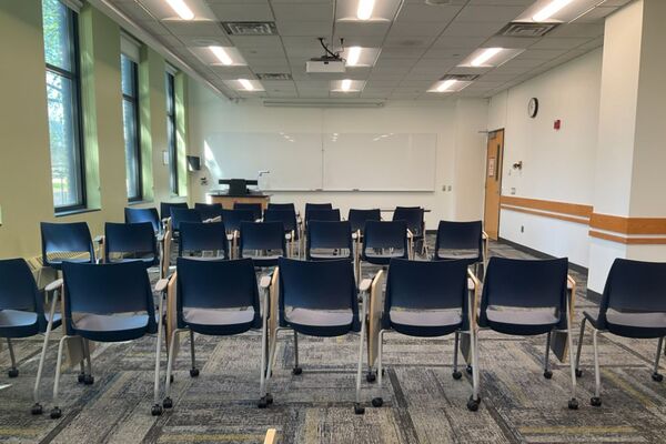 Front of room view with lectern on left in front of markerboard 