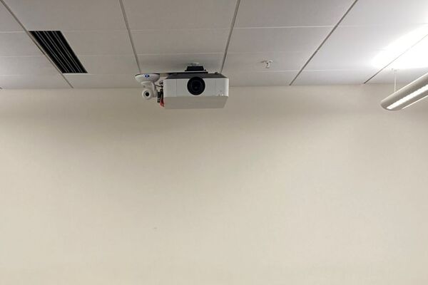 Camera mounted to ceiling and instructor enabled adjustments to the lens to allow the instructor to be "seen" by the camera in more locations around the room