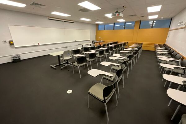 Front of room view with lectern on right in front of markerboard 