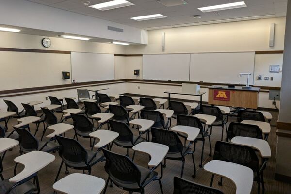 Front of room view with lectern on right in front of markerboard 