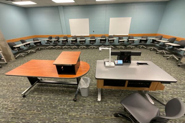 Back of room view of student tablet arm seating and markerboards on back wall
