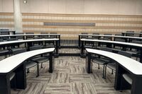 Back of room view of student tiered fixed-table and chair seating 