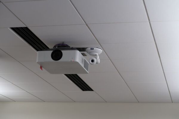 Camera mounted to ceiling and instructor enabled adjustments to the lens to allow the instructor to be "seen" by the camera in more locations around the room