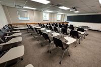 Front of room view with lectern on left in front of chalkboard