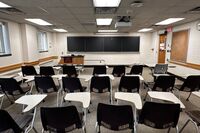 Front of room view with lectern on left in front of chalkboard