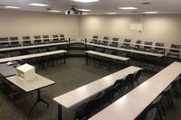 Back of room view of student tiered fixed table and chair seating