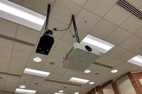 Camera mounted to a ceiling and instructor enabled adjustments to the lens to allow the instructor to be "seen" by the camera in more locations around the room