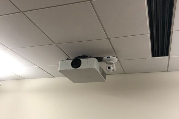 Camera mounted to ceiling and instructor enabled adjustments to the lens to allow the instructor to be "seen" by the camera in more locations around the room