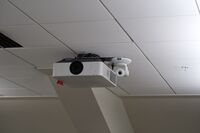 Camera mounted to ceiling and instructor enabled adjustments to the lens to allow the instructor to be "seen" by the camera in more locations around the room