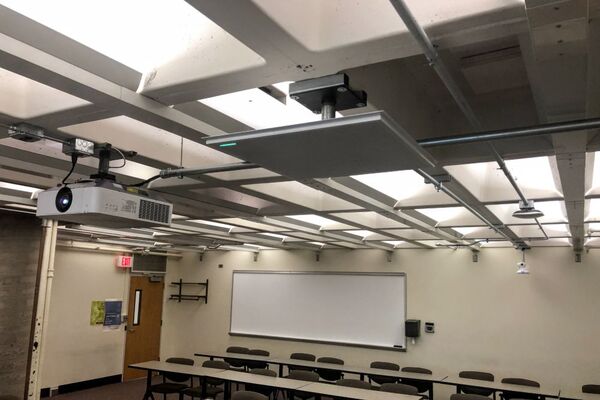 White 2¿ x 2¿ tile mounted to the ceiling to provide microphone coverage over student seating