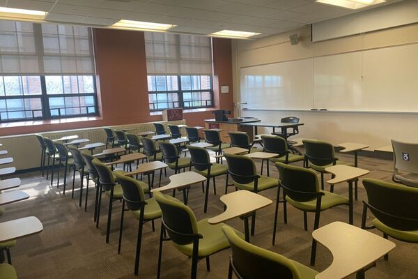 Front of room view with lectern on left in front of markerboard