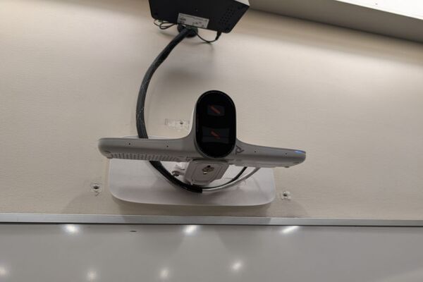 Camera mounted to front wall and instructor enabled adjustments to the lens to allow the room to be "seen" by remote participants